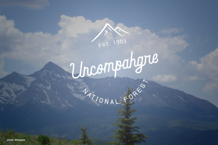 A scenic view of the Uncompahgre National Forest featuring majestic mountains under a blue sky with scattered clouds. The image depicts lush greenery in the foreground, leading to rugged mountain peaks, some capped with snow. The words "Uncompahgre National Forest" and "EST. 1905" are artistically overlaid on the image.