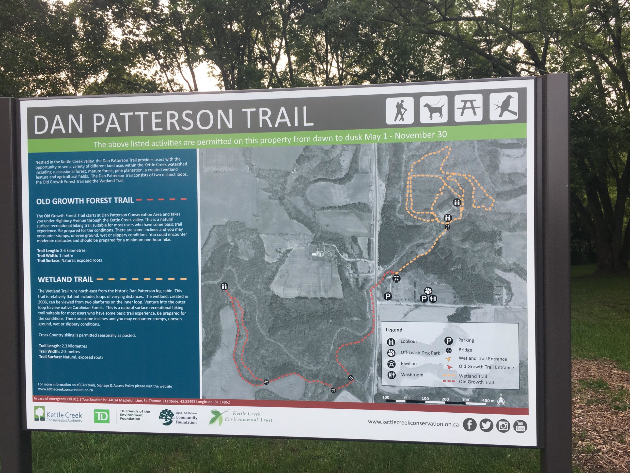 Signage for Dan Patterson Trail, detailing two trails: Old Growth Forest Trail and Wetland Trail. The map shows trail lengths, surface types, and locations of amenities like parking and a dog park. Designed for outdoor activities, the sign includes visitor guidelines and highlights the natural features of the Kettle Creek Valley. Dalewood (st.thomas) mountain bike trail.