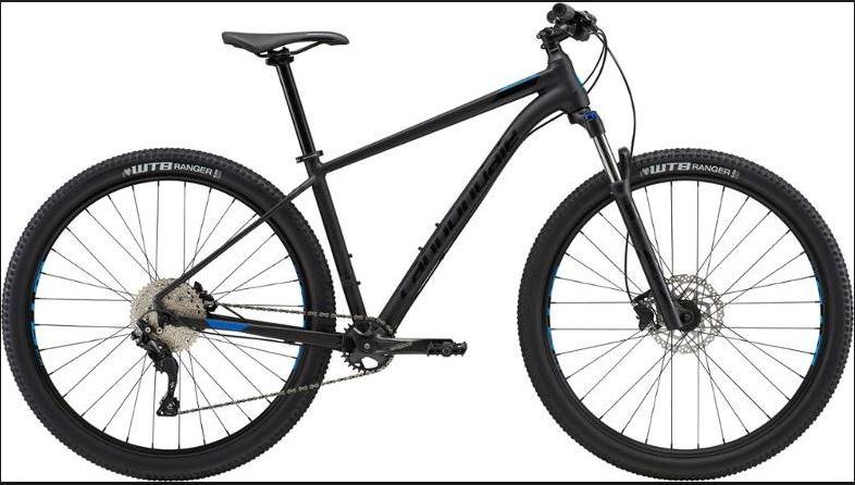 Cannondale Trail 5: A modern mountain bike with a black frame, featuring blue accents. It has wide tires labeled "WTB Ranger," a front suspension fork, and a sleek design suitable for off-road riding. The bike is shown at a slight angle to showcase its geometry and components.