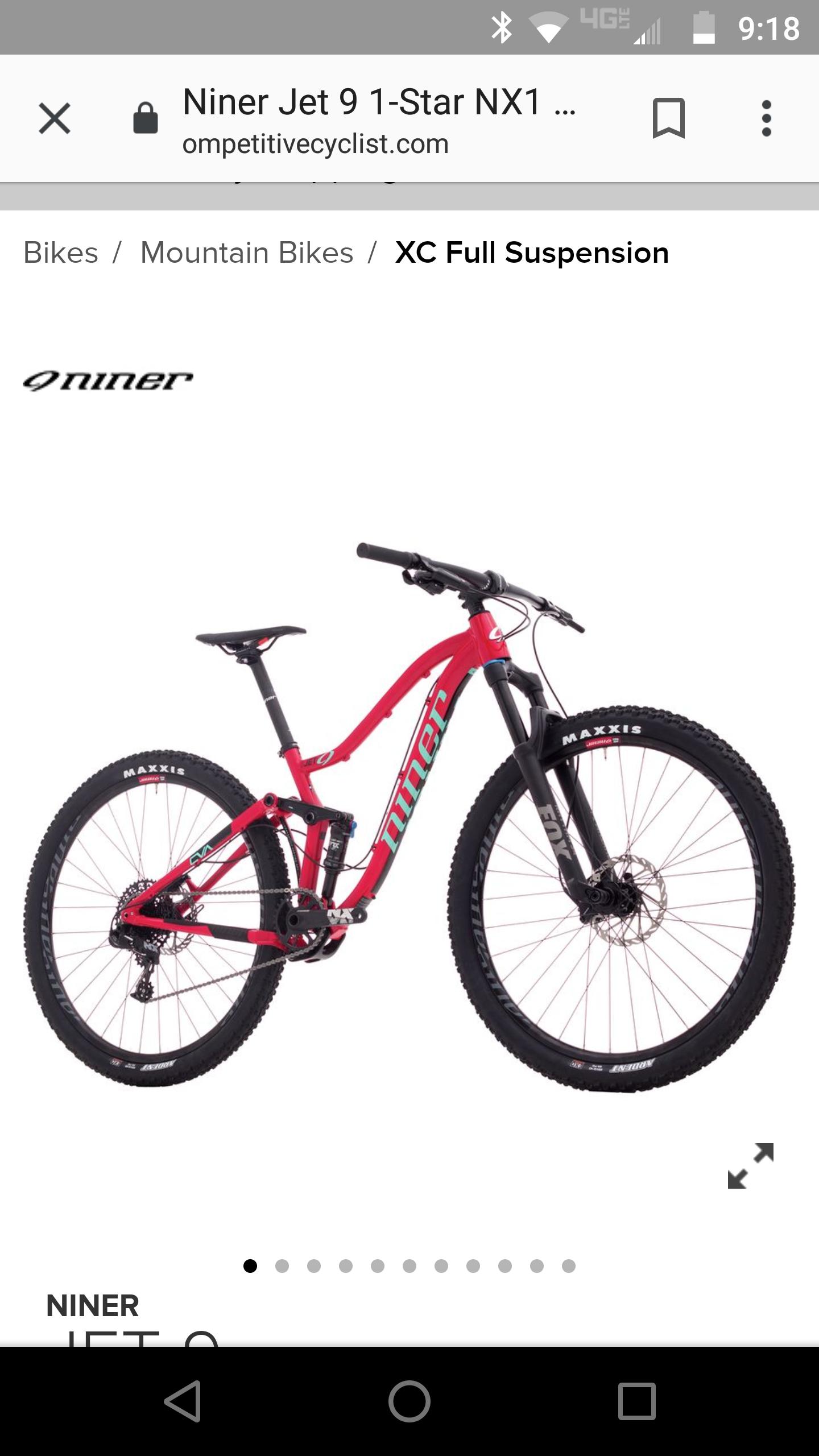 Niner Jet 9: Alt text: A red Niner Jet 9 1-Star NX1 mountain bike positioned on a white background, showcasing its full suspension design and Maxxis tires. The bike features a sleek frame design with prominent branding and a front suspension fork.