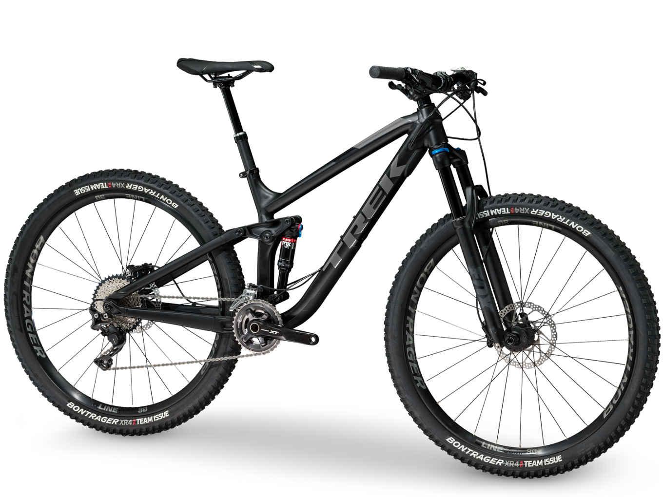 Trek Fuel EX 8 29: A black mountain bike with a sleek design, featuring wide tires, front suspension, and a multiple gear system. The bike has a lightweight frame and is equipped with Bontrager tires, ideal for rugged terrains.