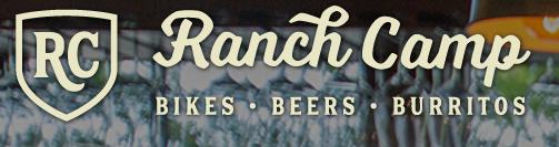 Logo for Ranch Camp featuring the text "Ranch Camp" with the tagline "Bikes • Beers • Burritos," presented in a stylish font against a blurred background.