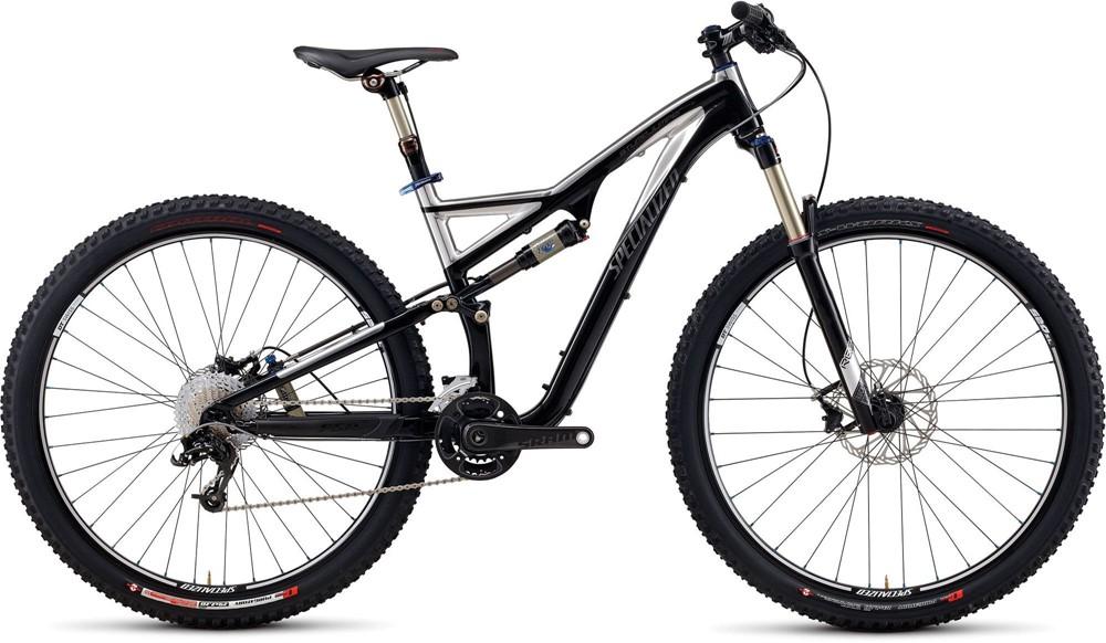 Specialized Stumpjumper FSR Expert 29: A side view of a black mountain bike featuring thick tires, a suspension frame, and a modern design. The bike includes disc brakes, a visible drivetrain, and a well-padded seat, showcasing its suitability for off-road cycling.