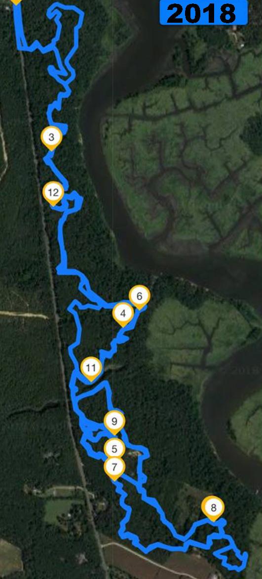 Map showing a winding blue trail marked with numbered points along a river and forested area, labeled "2018." Maurice River Bluffs Nature Preserve mountain bike trail.