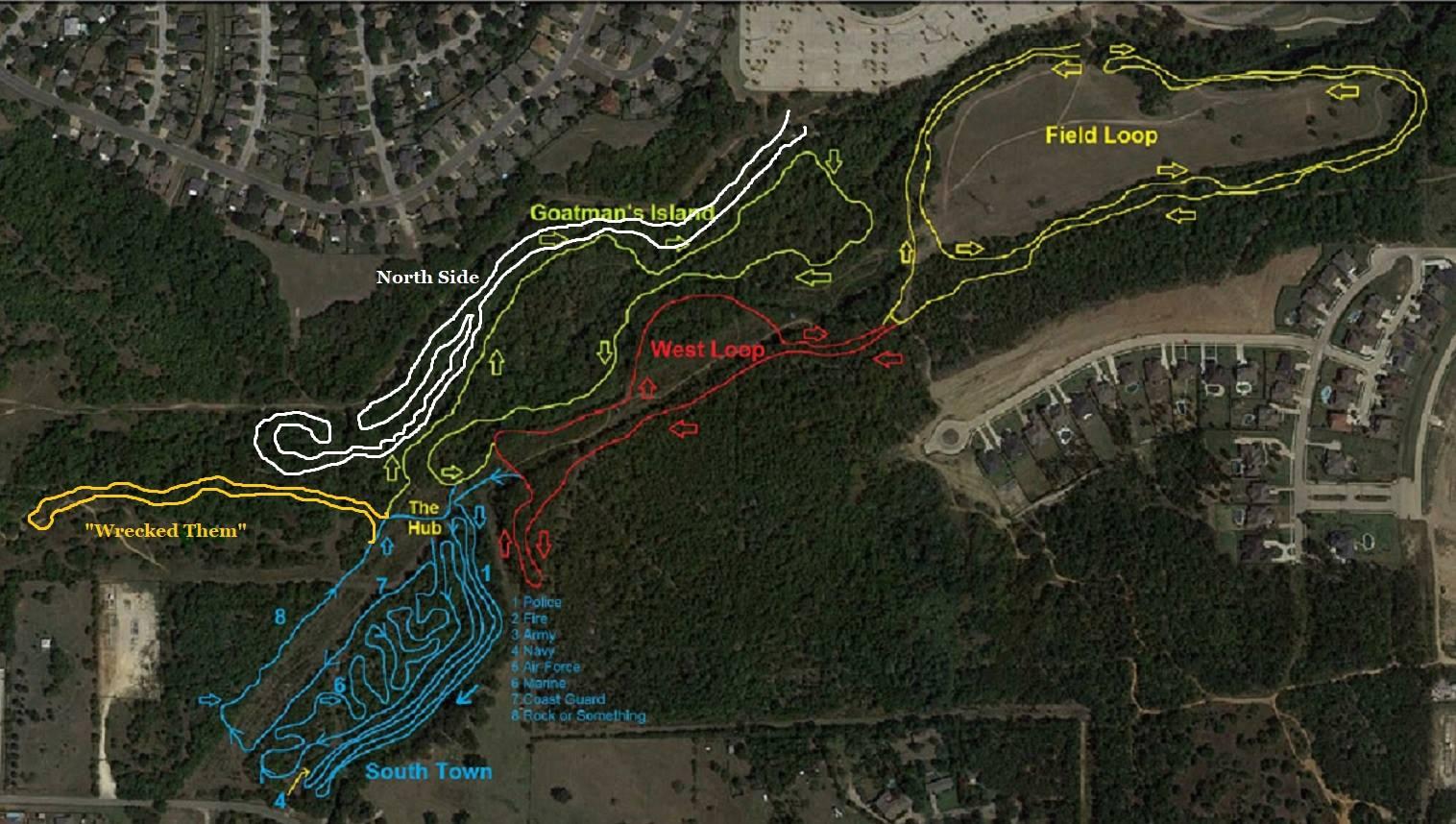A map showing various trails and loops in a wooded area, including routes labeled "North Side," "Goatman's Island," "West Loop," "Field Loop," and "South Town." The trails are depicted in different colors: red, yellow, blue, and white, with annotations for specific features like "The Hub" and "Wrecked Them." The surrounding area includes residential neighborhoods and a parking lot. Chisenhall trails mountain bike trail.