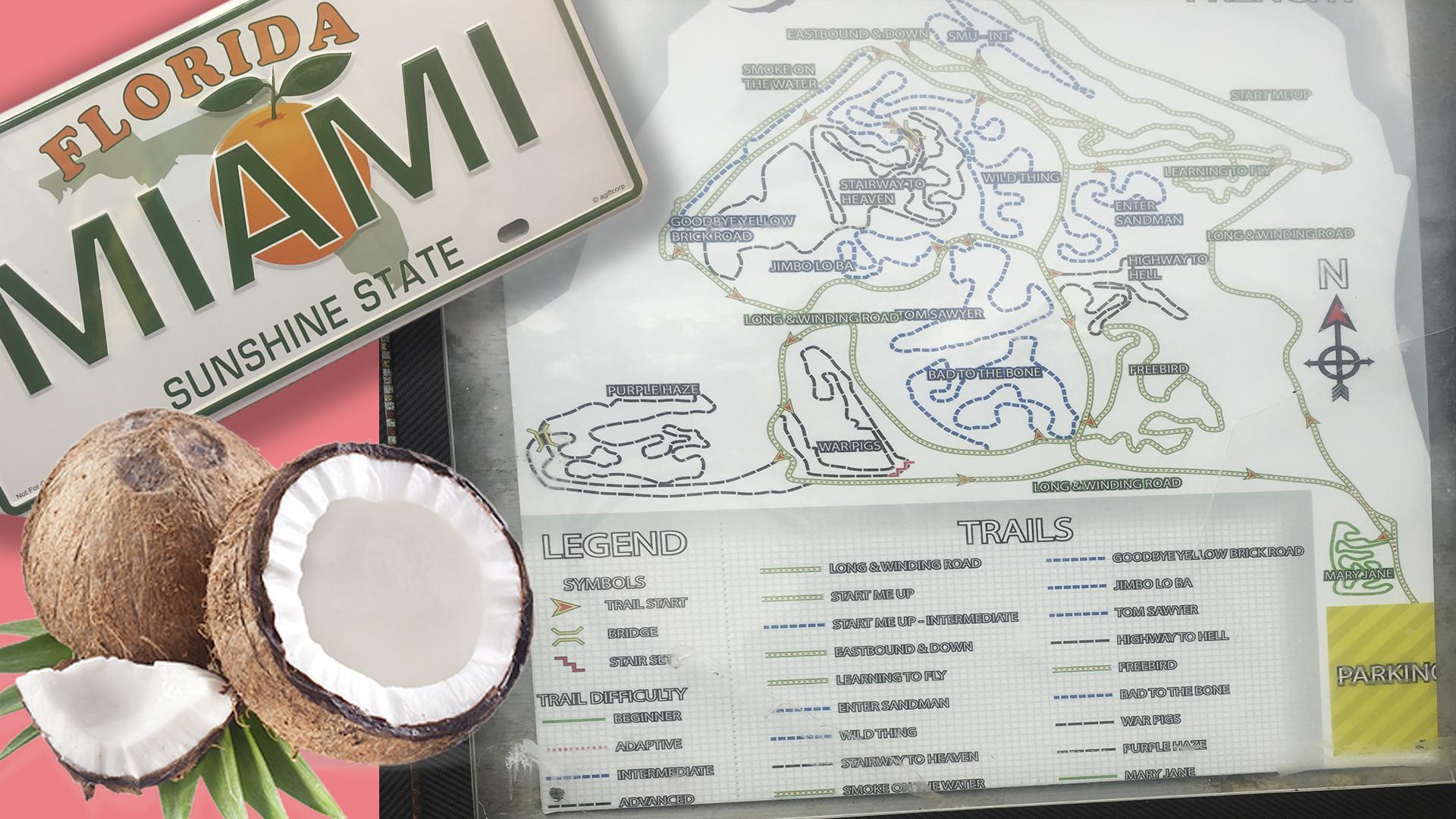 A Florida license plate featuring "MIAMI" and "SUNSHINE STATE," alongside a map detailing various trails, including labeled paths and difficulty levels. Coconut halves are displayed in the foreground, highlighting tropical elements. The map includes a legend for trail symbols and difficulty ratings, with locations named creatively, such as "Highway to Hell" and "Wild Thing." Virginia Key North Point mountain bike trail.