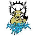 A cartoon-style illustration of a muscular deer with prominent antlers, making a fist gesture. The deer is depicted with a determined expression, and there is a gear or cog in the background. The text "Ko&scaron;utnjak MTB" is stylized in blue below the deer. Bike Park Josutnjak mountain bike trail.