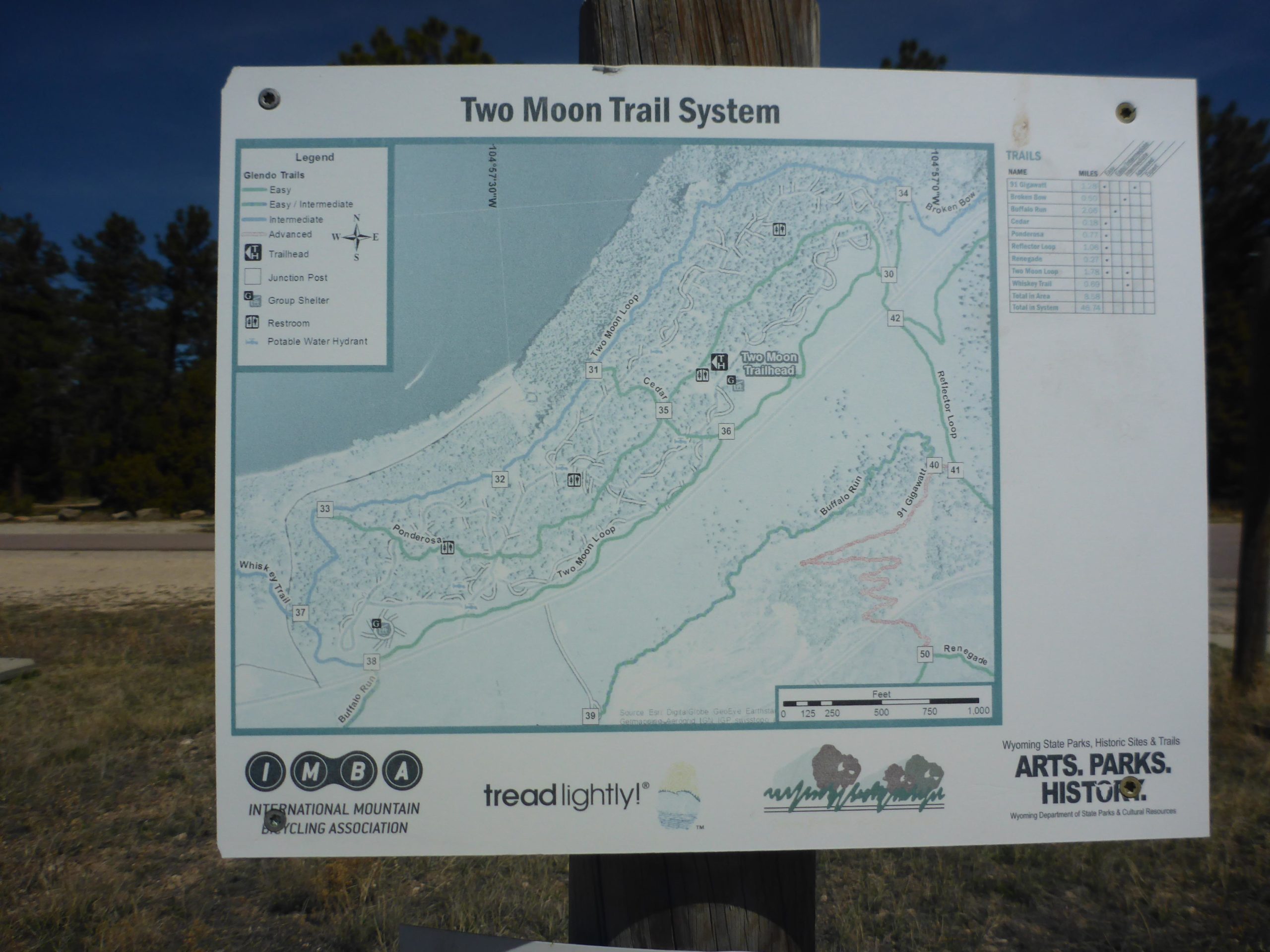A map of the Two Moon Trail System, showing various trails with designated difficulty levels (easy, intermediate, advanced), trail names, and key landmarks such as the trailhead, restrooms, and parking areas. The map includes a legend and scale for orientation. Glendo State Park mountain bike trail.