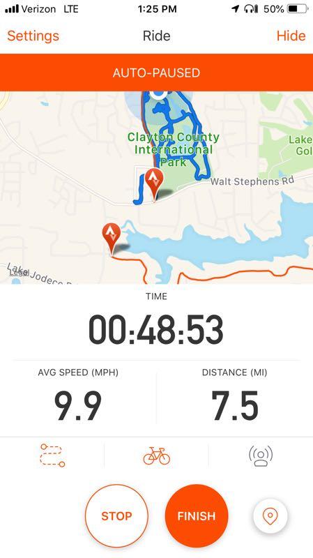 Alt text: Screenshot of a fitness tracking app showing an auto-paused ride summary with a map. Total time is 48 minutes and 53 seconds, average speed is 9.9 mph, and distance covered is 7.5 miles. The map highlights a route around Clayton County International Park. The Trails At The Beach mountain bike trail.