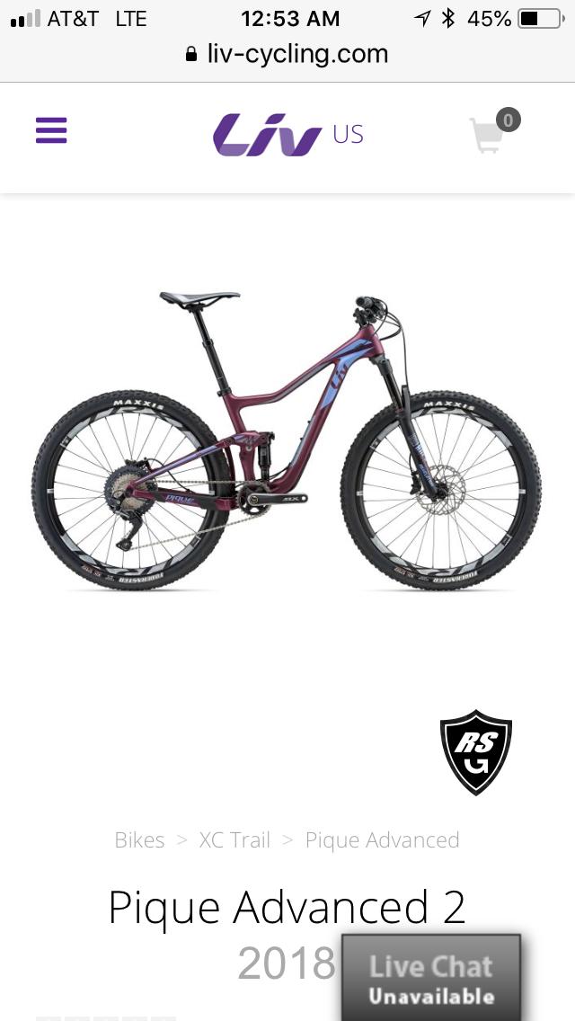 LIV Pique: Alt text: A purple and black Liv Pique Advanced 2 mountain bike displayed on a white background. The bike features a full suspension frame, large knobby tires, and a modern design suitable for cross-country trail riding.