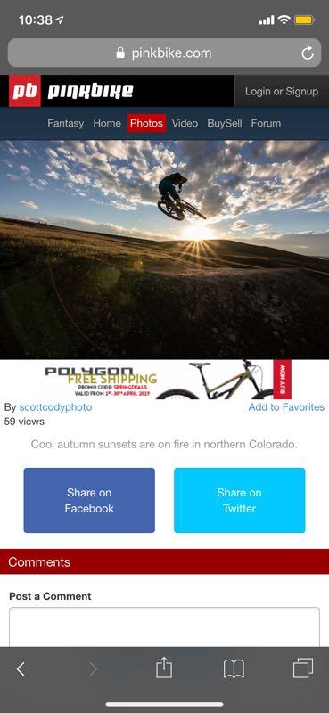 A mountain biker jumps mid-air against a backdrop of a vibrant sunset, with dramatic clouds illuminated by orange and yellow hues, set in a northern Colorado landscape during autumn. Booster canyon mountain bike trail.