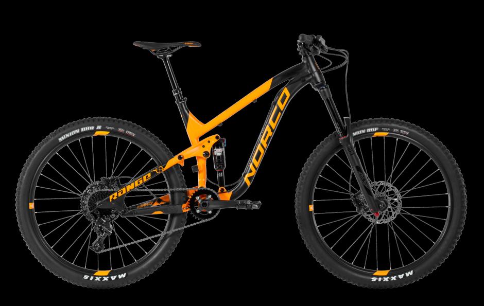 Norco Norco Range A7.3: An orange and black mountain bike, featuring a sturdy frame, wide tires, and disc brakes, displayed against a black background. The bike is a Norco model, highlighting its suspension system and gear components.
