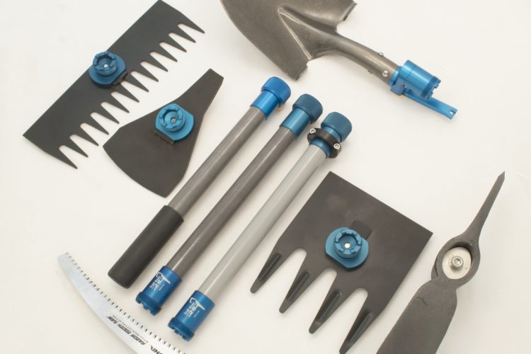 A collection of gardening tools arranged on a white background, including a metal shovel, various rake heads, a curved saw, and multiple tool handles with blue and gray connections, designed for modular versatility.