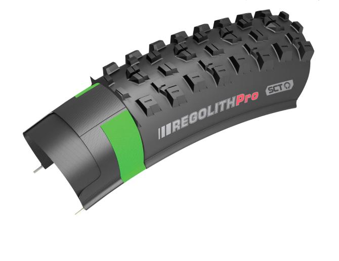 Kenda Regolith: A close-up image of a mountain bike tire, showing the tread pattern and sidewall design. The tire features the "Regolith Pro" branding in bold lettering, with green accents highlighting specific areas of the tire. The tread is designed for enhanced grip and traction on off-road surfaces.