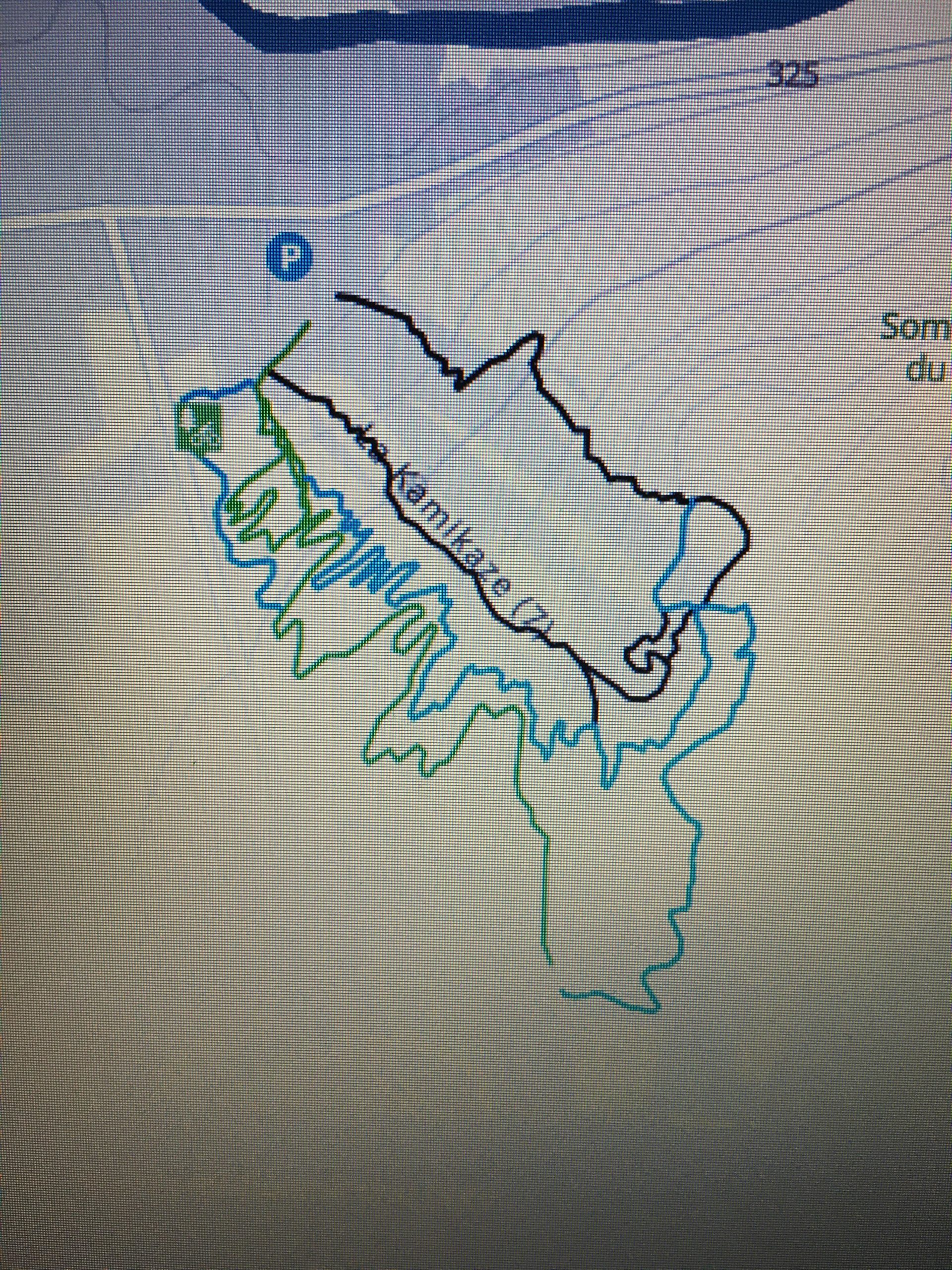 Map featuring a trail layout with various paths marked in different colors. The paths labeled include "Kamikaze" and are highlighted in black and blue, indicating various routes. Parking and map key icons are visible, suggesting the area is for outdoor activities. Mont Rigaud mountain bike trail.