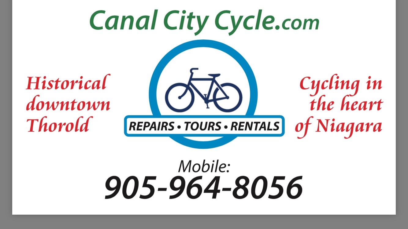 Sign for Canal City Cycle with text promoting bike repairs, tours, and rentals in Thorold, Ontario. Features a bicycle graphic and contact number.