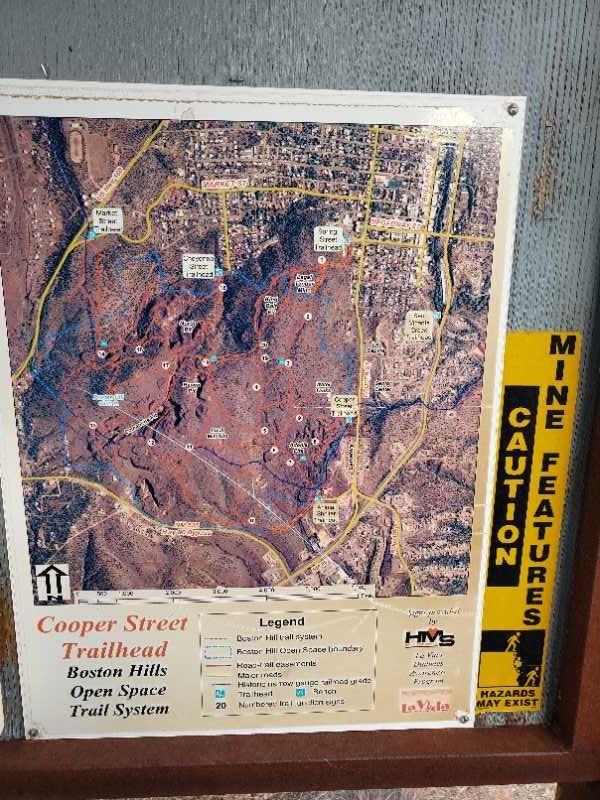Map providing information about the Cooper Street Trailhead in the Boston Hills, detailing various trail routes and open spaces, with a caution sign indicating potential mine features in the area. Boston Hill mountain bike trail.
