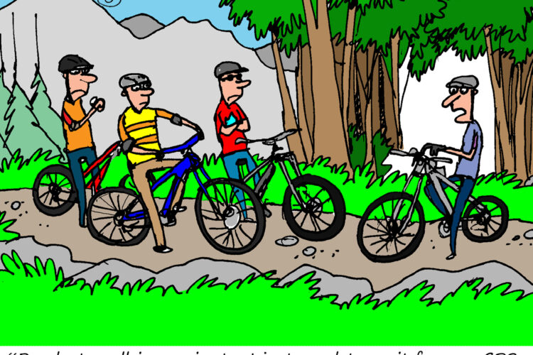 A cartoon depicting four mountain bikers on a trail, surrounded by trees and mountains. One biker, wearing a yellow and black striped shirt, looks at his watch as he prepares to ride. The others are patiently waiting on their bikes. A humorous speech bubble from the striped biker reads, "Ready to roll in a minute, I just need to wait for my GPS, seatpost, derailleur, earbuds and pump to charge up."