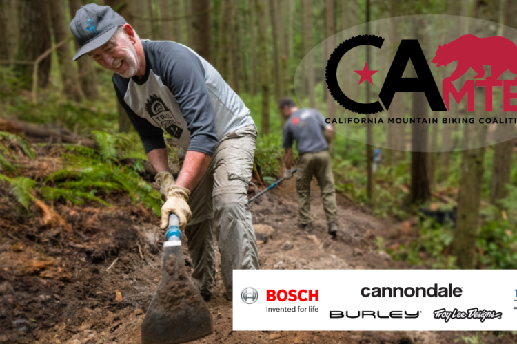 Two people are working on a trail in a forested area, using shovels and other tools to maintain the path. One person, wearing a cap and a long-sleeve shirt, is smiling as they dig into the ground, while the other person is in the background, also engaged in trail work. The scene features lush greenery and trees, emphasizing an outdoor, community-driven effort. Logos for the California Mountain Biking Coalition and several sponsors are displayed prominently in the image.