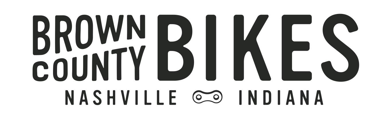 Logo for Brown County Bikes, featuring bold text with the words "BROWN COUNTY" and "BIKES" prominently displayed, along with "NASHVILLE" and "INDIANA" beneath. The design includes a bicycle chain graphic, emphasizing a biking theme.