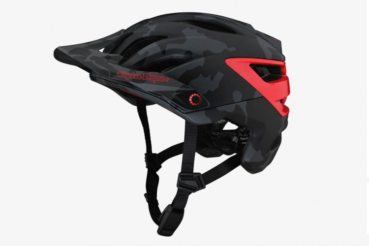 Black and red cycling helmet with a camouflage pattern, featuring ventilation slots, a sleek design, and adjustable straps. The helmet is angled to showcase its profile and brand logo.