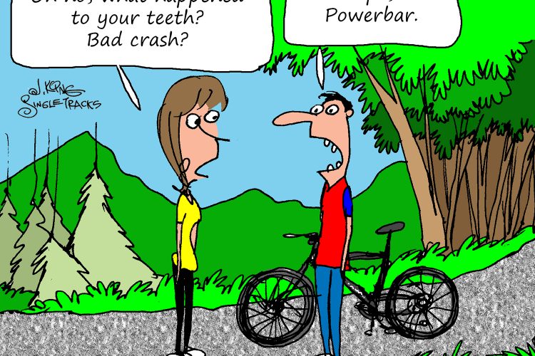 A cartoon depicting a conversation between two characters on a bike path in a green, outdoor setting. A woman with brown hair and a yellow shirt expresses concern about a man's teeth, questioning if he had a bad crash. The man, wearing a red and blue shirt, responds humorously, saying his teeth are fine and it's just a Powerbar. A bike rests beside him, adding to the context of outdoor cycling.