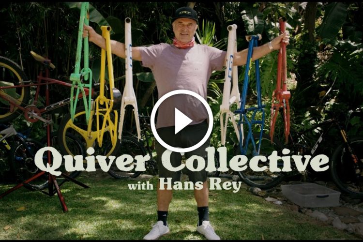 A person holding four colorful bicycle frames in a garden setting, with various bikes in the background. The text overlay reads "Quiver Collective with Hans Rey."