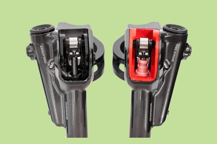 Cross-sectional view of two bicycle brake levers, showcasing internal mechanics. The left lever features a sleek black design, while the right lever is highlighted with a red interior. Both are set against a light green background.