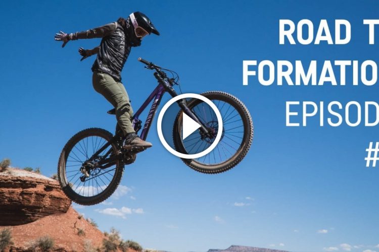 A mountain biker performing a jump against a clear blue sky, with a rocky landscape in the foreground. Text on the image reads "Road to Formation Episode #3."