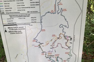 Map of the Moraine State Forest-Southern Unit trail system, including various trails for hiking and biking. The map outlines trail features, lengths, difficulty levels, and specific loop names, marked in different colors. Trail intersections and directional guidelines for bikers and hikers are also indicated. Kettle Moraine John Muir + Emma Carlin mountain bike trail.
