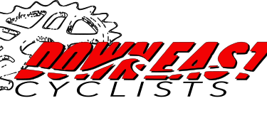 Text logo featuring the word "DOWNEAST" in bold red letters, with a dynamic, wavy design, set against a black background. Henderson Pond / Camp Lejeune mountain bike trail.