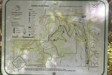 Map of Cedar Niles Park, showing trails, parking areas, and facilities, with a legend indicating trail difficulty levels and park features, alongside a notice about trail closures and conditions. Cedar Niles Park mountain bike trail.