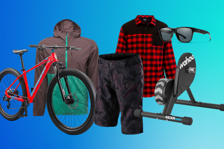 Image showcasing outdoor and cycling gear, including a red mountain bike, a brown jacket, a red and black checkered shirt, black shorts with a floral design, sunglasses, and a Wahoo Kickr Core smart trainer, all set against a blue gradient background.