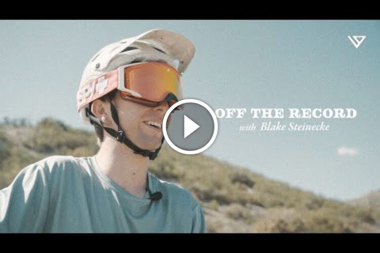 A young man wearing a helmet and goggles smiles while outdoors, with hills in the background. The image features the text "Off the Record with Blake Steinecke" prominently displayed.