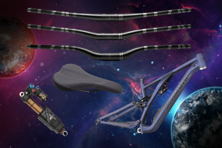 A collection of mountain bike components displayed against a cosmic background, featuring three black handlebars, a bicycle seat, a shock absorber, and a purple bike frame. The scene is set in a colorful space environment, with planets and stars visible in the background.