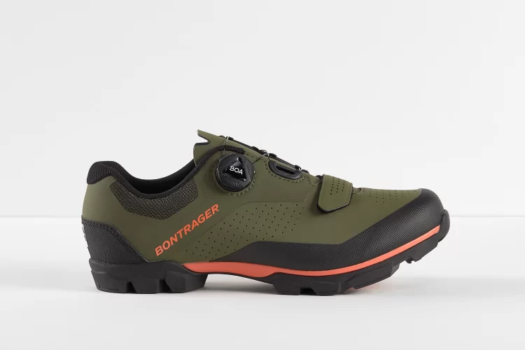 Alt tag: Side view of a green Bontrager cycling shoe with a black and orange sole, featuring a Boa dial closure and perforated detailing.