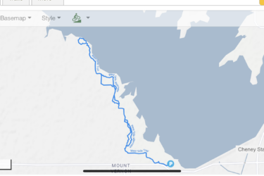Map showing the West Side Trail route along a lake, with marked starting points and distances. The map includes terrain details and various overlay options, such as biking routes and park trails. Cheney Lake Main Trail mountain bike trail.