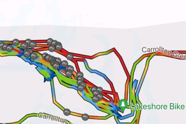 Map displaying bike paths around Lakeshore Bike Trail, featuring multi-colored lines indicating different routes and several markers along the paths. Street names include Lakewood Drive and Cathy Circle, with significant points like Carrollton Greenbelt and Lakeshore Bike clearly labeled. Lakeshore Bike Park mountain bike trail.