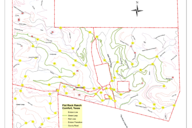 Map of Flat Rock Ranch located in Comfort, Texas, showing various trails and roadways. Features include contour lines, different trail loops marked in green and red, and key locations identified with yellow numbers. The map also includes a compass rose indicating north and outlines the boundaries of the ranch. Flat Rock Ranch mountain bike trail.