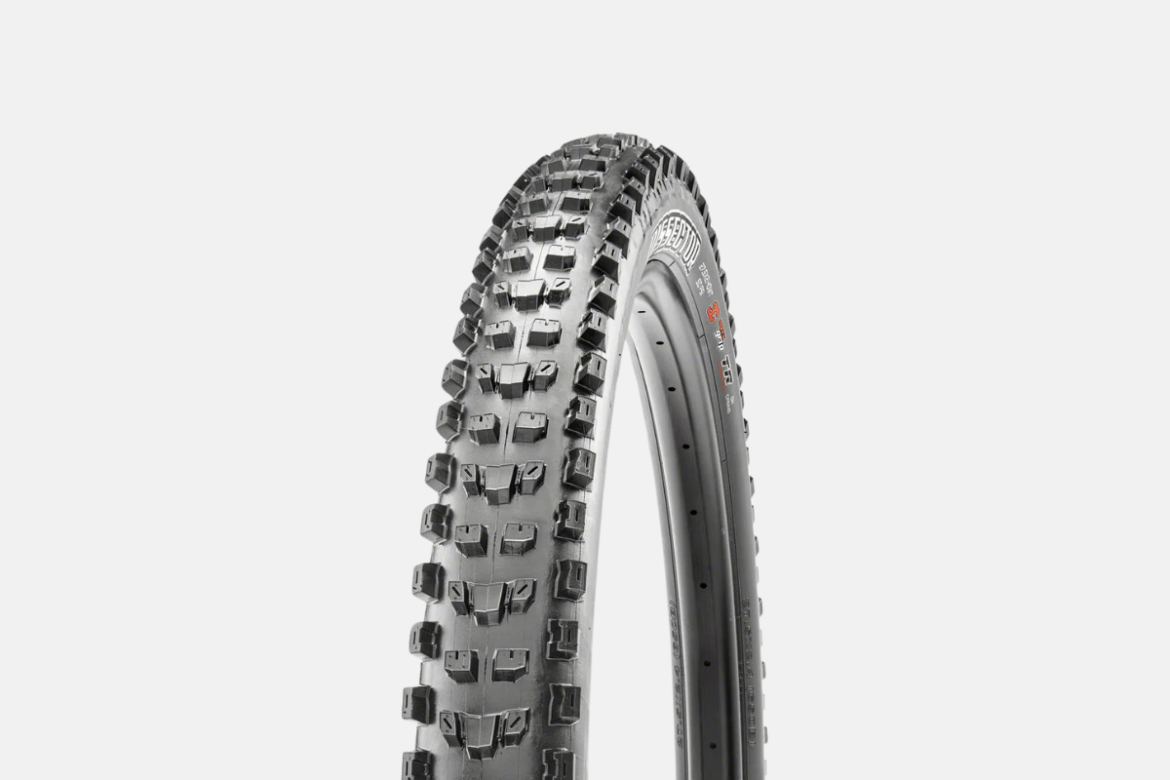 A close-up image of a mountain bike tire featuring a rugged tread pattern designed for traction on various terrains. The tire has a black rubber surface with raised, angular knobs for grip. It is displayed against a plain white background, emphasizing its details and design.