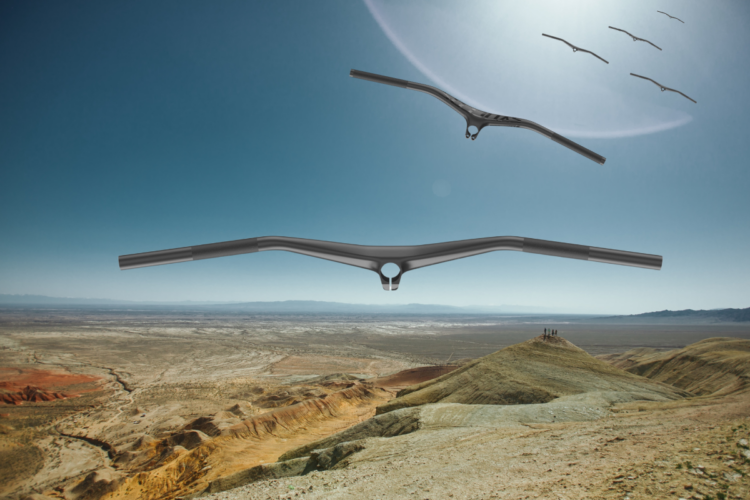 A creative image featuring a pair of bicycle handlebars floating in a vast desert landscape under a clear blue sky. In the background, mountains are visible, with a small group of people on a hilltop. The scene evokes a sense of adventure and freedom in outdoor cycling.