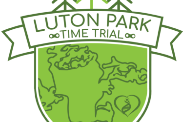 Logo for the Luton Park Time Trial featuring a green shield design with a map outline of the park, flanked by stylized trees at the top and the event name prominently displayed in bold text. A heart shape with a DNA strand icon is included at the bottom of the shield.