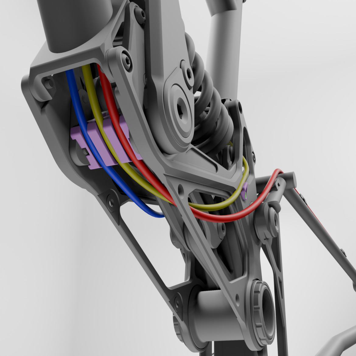 Close-up view of a mechanical assembly, featuring colorful wires in red, blue, yellow, and purple, integrated within a gray framework. The image highlights components like a shock absorber and mounting points, set against a light background.