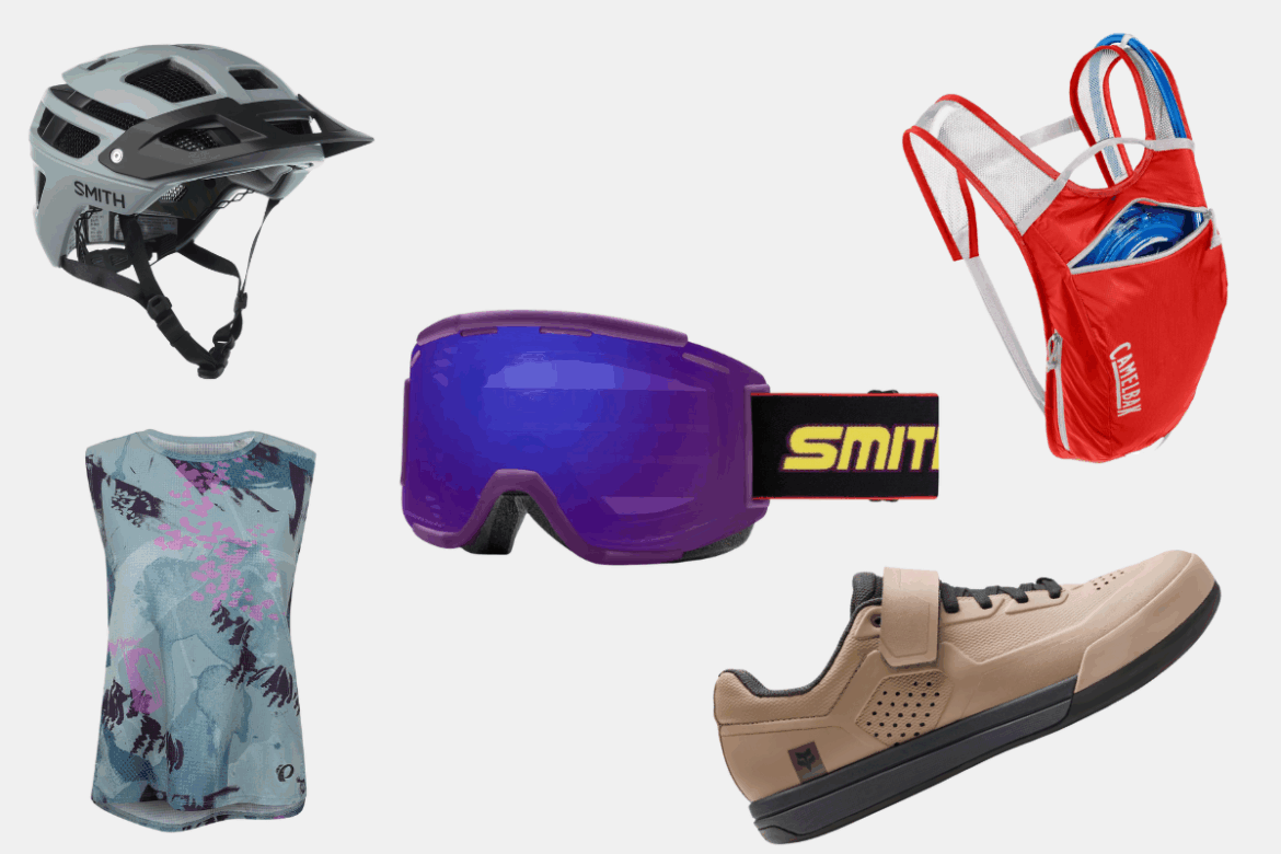A selection of outdoor sports gear including a gray bike helmet, purple ski goggles with a black strap, a colorful sleeveless top featuring a graphic design, a red hydration backpack with a clear water reservoir, and light brown athletic shoes designed for biking.