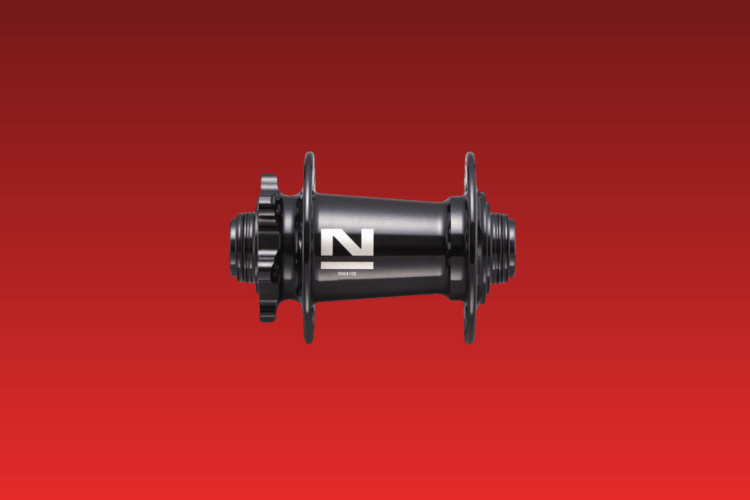 A black bicycle hub with prominent flanges and a silver logo on the side, centered against a red gradient background.