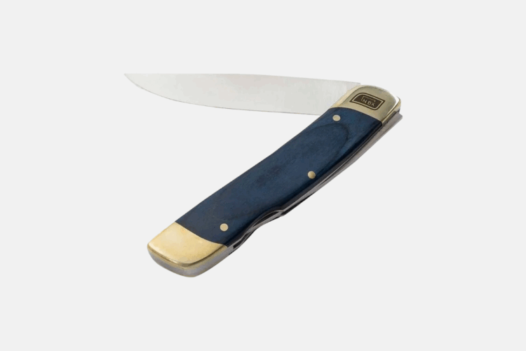 A folded pocket knife with a shiny metal blade and a handle made of blue material, featuring gold accents and small decorative rivets. The knife is positioned to show both the blade and the handle clearly.