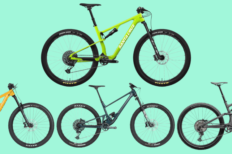 Four mountain bikes displayed against a light teal background. The bikes vary in color, with one bright green bike prominently featured in the center, alongside an orange bike on the left, a dark blue bike below it, and a black bike on the right. Each bike showcases distinctive designs and features, emphasizing their suitability for off-road biking.