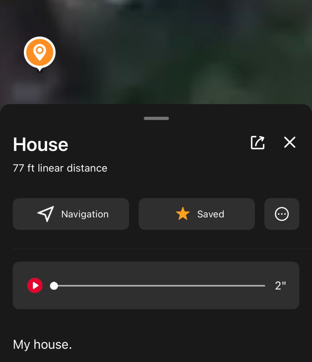 An interface displaying a location marker for a house, showing a linear distance of 77 feet. The screen includes options for navigation, saving the location, and a playback feature with a slider. The background appears blurred, indicating an outdoor setting.