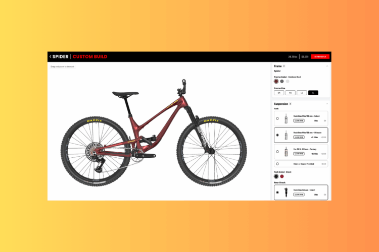 A custom-built mountain bike displayed with a sleek design in an oxblood red frame. The image showcases the bike from the side, highlighting its large wheels and suspension components. On the right side, there are options for selecting frame size, suspension specifications, and color customization. The background features a gradient yellow to orange transition.