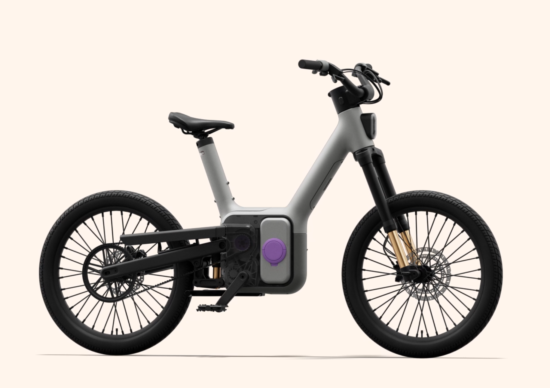 A modern electric bike with a sleek gray frame, featuring a minimalist design. It has a single seat, a prominent battery casing with a purple accent, and thick black tires. The bike showcases front suspension forks and disc brakes, emphasizing both style and functionality. The background is a soft beige color, highlighting the bike's design.